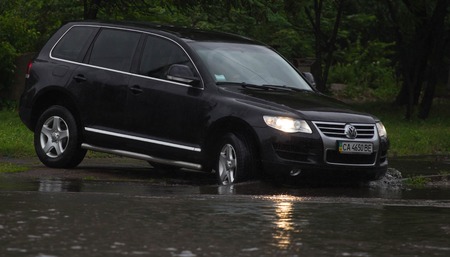 CHERKASSY, UKRAINE- JUNE 27, 2015: cars driving on a flooded road during a flood caused by heavy...