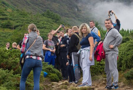 GOVERLA, UKRAINE - SEPTEMBER 20, 2015 : A group of tourists climbs to the highest mountain of Ukraine Hoverla 2061 METER on SEPTEMBER 20, 2015のeditorial素材