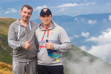 GOVERLA, UKRAINE - SEPTEMBER 20, 2015 : A group of tourists climbs to the highest mountain of Ukraine Hoverla 2061 METER on SEPTEMBER 20, 2015のeditorial素材