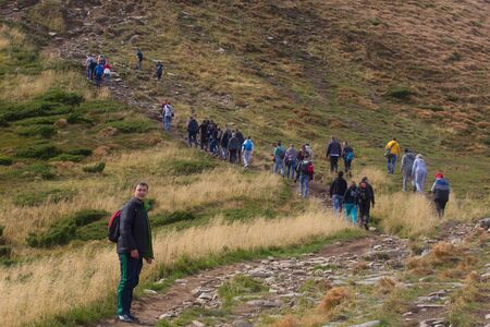 GOVERLA, UKRAINE - SEPTEMBER 20, 2015 : A group of tourists climbs to the highest mountain of Ukraine Hoverla 2061 METER on SEPTEMBER 20, 2015のeditorial素材