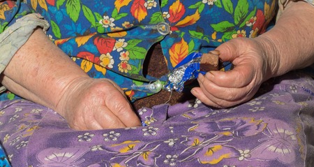senior person holding in hands chocolate candy
