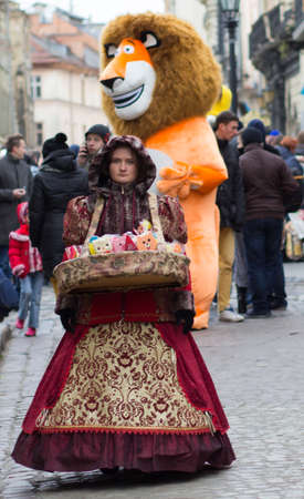 LVIV, UKRAINE - November 15: The girl in a beautiful suit sells candy in Lviv Market Square landmark...