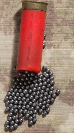 Hunting cartridges and lead shot, clouse up. camouflage backgroundの写真素材