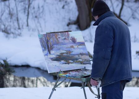 the artist drawing a  landscape during winterの写真素材