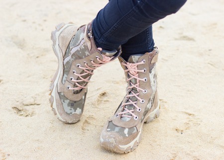 military or hiking boots in the sand. Clouse up