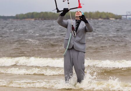 Cherkasy, Ukraine - APRIL 21, 2016: Male office workers in suits ride kites. Business and Sports Festival.のeditorial素材