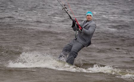 Cherkasy, Ukraine - APRIL 21, 2016: Male office workers in suits ride kites. Business and Sports Festival.のeditorial素材