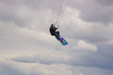 Cherkasy, Ukraine - APRIL 21, 2016: Male office workers in suits ride kites. Business and Sports Festival.のeditorial素材