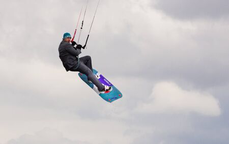 Cherkasy, Ukraine - APRIL 21, 2016: Male office workers in suits ride kites. Business and Sports Festival.のeditorial素材