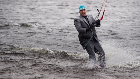 Cherkasy, Ukraine - APRIL 21, 2016: Male office workers in suits ride kites. Business and Sports Festival.のeditorial素材
