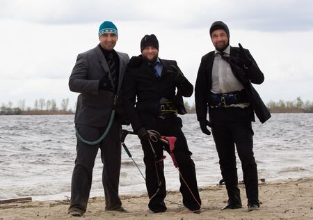 Cherkasy, Ukraine - APRIL 21, 2016: Male office workers in suits ride kites. Business and Sports Festival.のeditorial素材
