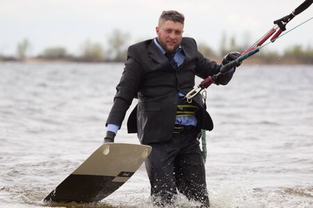 Cherkasy, Ukraine - APRIL 21, 2016: Male office workers in suits ride kites. Business and Sports Festival.のeditorial素材