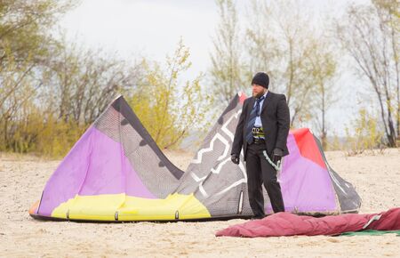 Cherkasy, Ukraine - APRIL 21, 2016: Male office workers in suits ride kites. Business and Sports Festival.のeditorial素材