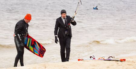 Cherkasy, Ukraine - APRIL 21, 2016: Male office workers in suits ride kites. Business and Sports Festival.のeditorial素材