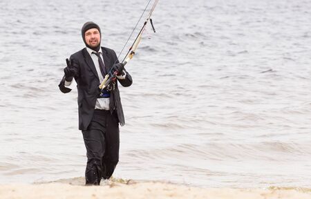 Cherkasy, Ukraine - APRIL 21, 2016: Male office workers in suits ride kites. Business and Sports Festival.のeditorial素材