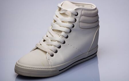 white sneaker shoe and clutch bag on white backgroundの写真素材