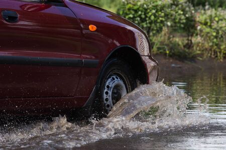 CHERKASSY, UKRAINE- JUNE 5, 2016: cars driving on a flooded road during a flood caused by heavy rain, in Cherkassy.のeditorial素材