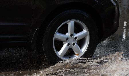 CHERKASSY, UKRAINE- JUNE 5, 2016: cars driving on a flooded road during a flood caused by heavy rain, in Cherkassy.のeditorial素材