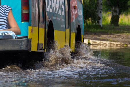 CHERKASSY, UKRAINE- JUNE 5, 2016: cars driving on a flooded road during a flood caused by heavy rain, in Cherkassy.のeditorial素材