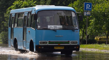 CHERKASSY, UKRAINE- JUNE 5, 2016: cars driving on a flooded road during a flood caused by heavy rain, in Cherkassy.のeditorial素材