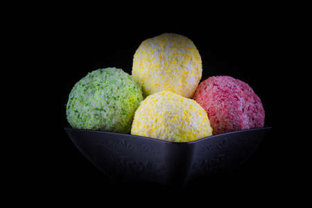 Color Ice cream scoops with caramel chips. Black backgroundの写真素材