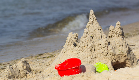 Built House sand castle with towers on the south shore of the sandy beach sea