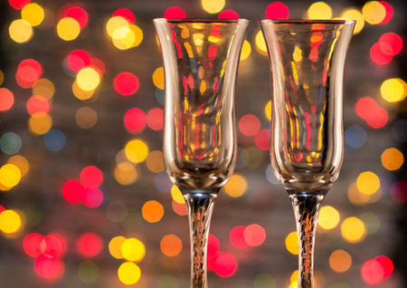 two glasses of champagne for the lovers in the new year. Dinner by candlelight with a beautiful bokehの写真素材