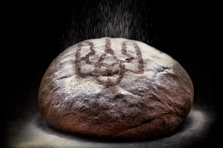 Loaf of wheat bread on rustic background. Urraine trident emblemの写真素材