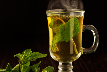 Cup with green tea and mint leaves.の写真素材