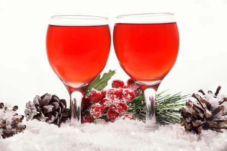 love, romance, holiday, celebration concept - wine glasses on the snow.の写真素材