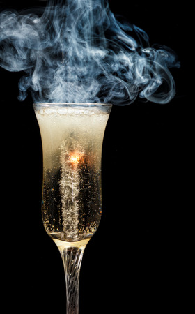 glass of champagne with smoke. Tempest in a teapotの写真素材