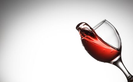 Red wine splash on the white backgroundの写真素材