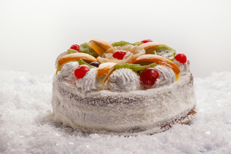 beautiful cake with berries, orange and kiwiの写真素材