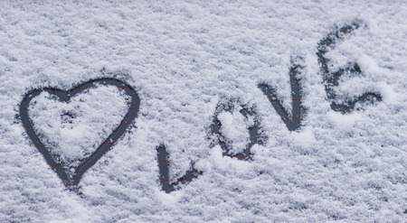 The shape of heart on the snow. Closeup shotの写真素材