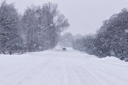 Cars with winter tires on snow-covered road