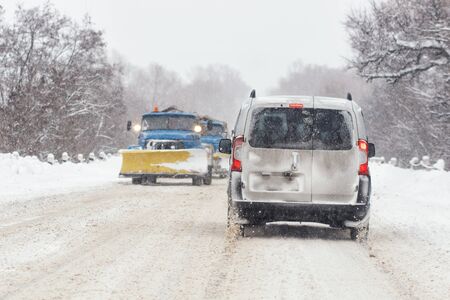 Snow-removal machine cleans the street of snowの写真素材