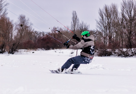 Snowboarder with kite on free ride.の写真素材
