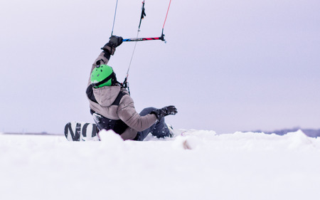 Snowboarder with kite on free ride.の写真素材