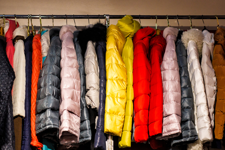 Colorful women's dresses on hangers in a retail shop. Fashion and shopping concept.の写真素材