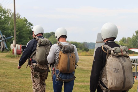 Sutiski, Ukraine - June 24, 2017: Skydivers carries a parachute after landing. Skydive Ukraine is the skydiving center located at Sutiski Aerodrome, about 20 km southwest of Vinitsa, Ukraine.のeditorial素材