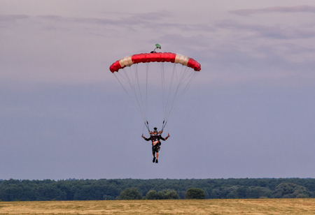 Sutiski, Ukraine - June 24, 2017: Skydivers carries a parachute after landing. Skydive Ukraine is the skydiving center located at Sutiski Aerodrome, about 20 km southwest of Vinitsa, Ukraine.のeditorial素材