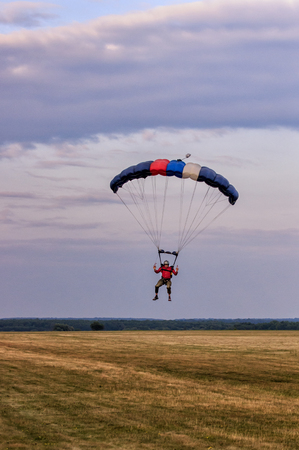 Sutiski, Ukraine - June 24, 2017: Skydivers carries a parachute after landing. Skydive Ukraine is the skydiving center located at Sutiski Aerodrome, about 20 km southwest of Vinitsa, Ukraine.のeditorial素材