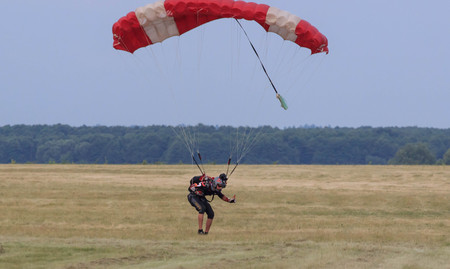 Sutiski, Ukraine - June 24, 2017: Skydivers carries a parachute after landing. Skydive Ukraine is...