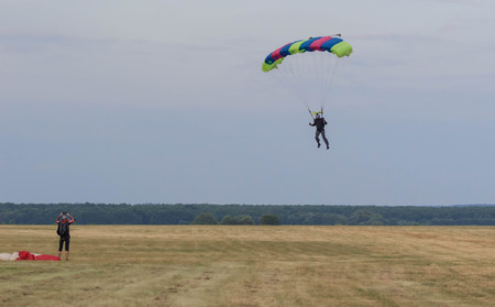 Sutiski, Ukraine - June 24, 2017: Skydivers carries a parachute after landing. Skydive Ukraine is the skydiving center located at Sutiski Aerodrome, about 20 km southwest of Vinitsa, Ukraine.のeditorial素材