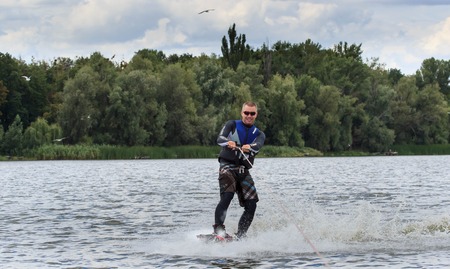 VATUTINE, UKRAINE - JULY 15: The athlete enjoys wakeboarding and coaches tricks on July 15, 2017 in Vatutine, Ukraineのeditorial素材