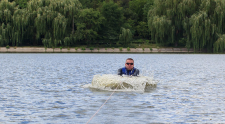 VATUTINE, UKRAINE - JULY 15: The athlete enjoys wakeboarding and coaches tricks on July 15, 2017 in Vatutine, Ukraineのeditorial素材