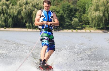 VATUTINE, UKRAINE - JULY 15: The athlete enjoys wakeboarding and coaches tricks on July 15, 2017 in Vatutine, Ukraineのeditorial素材