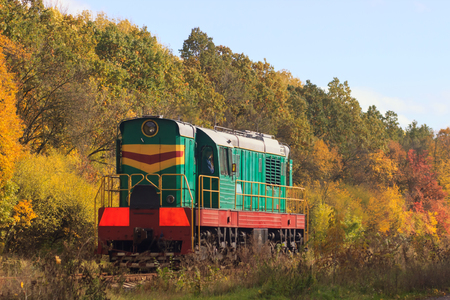 Railway or tramway track in a beautiful autumn park fog. dampness, bright warm autumn colors