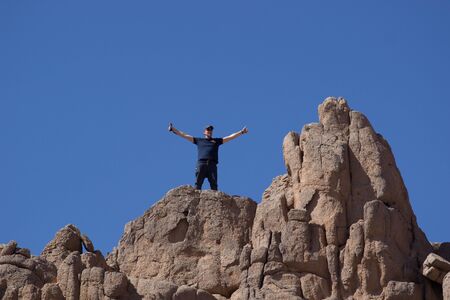 Sharm El Sheikh, Egypt - January 24, 2018: Man is feeling freedom in the top of the mountianのeditorial素材