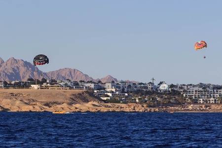 Sharm El Sheikh, Egypt - February 3 2018: Tourists are extremely entertained flying parasailing.のeditorial素材